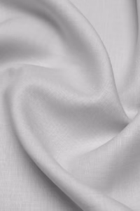 man-wearing-light-grey-linen-shirt-sitting-on-sofa