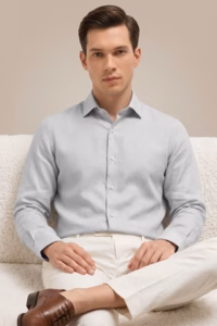 man-wearing-light-grey-linen-shirt-sitting-on-sofa